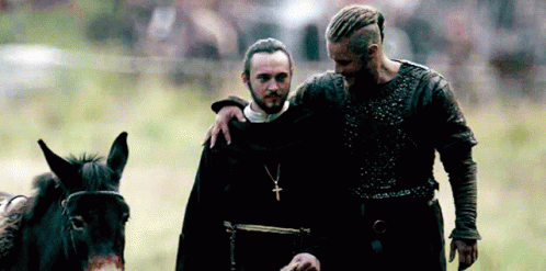 Bearded Man Beside Man With Cross Necklace GIF