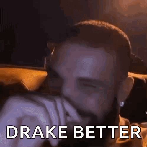 Bearded Man Covering Mouth in Car Drake Better