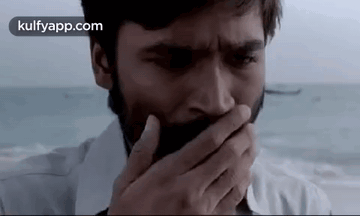 Bearded Man Covering Mouth With Hand