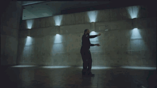 Bearded Man Dancing in Dark Room