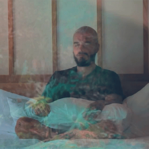Bearded Man Eyes Closed Smoking on Bed