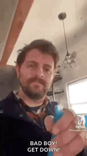 Bearded Man Holding Blue Object Saying Bad Boy GIF