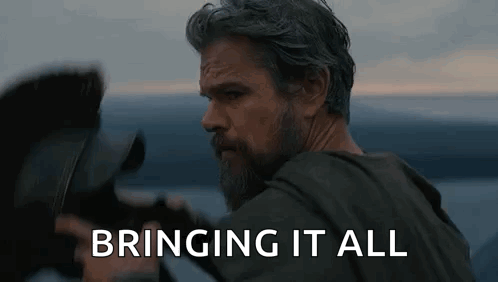 Bearded Man Holding Camera In Front Of Water GIF