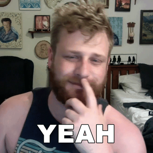 Bearded Man Holding Finger To Nose In Front Of Yeah Sign GIF