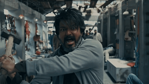 Bearded Man Holding Large Hammer