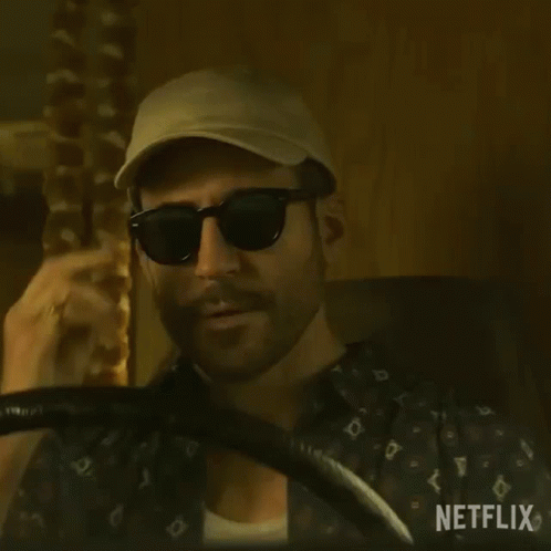 Bearded Man Holding Steering Wheel and Hat