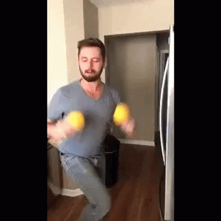 Bearded Man Holding Two Lemons GIF