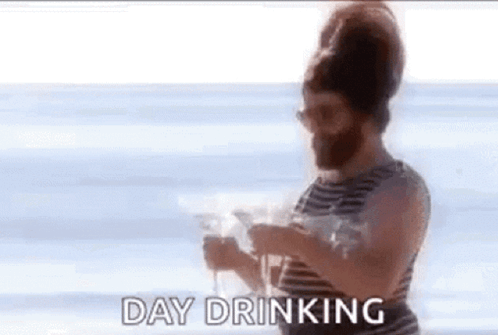 Bearded Man Holding Wine On Beach GIF