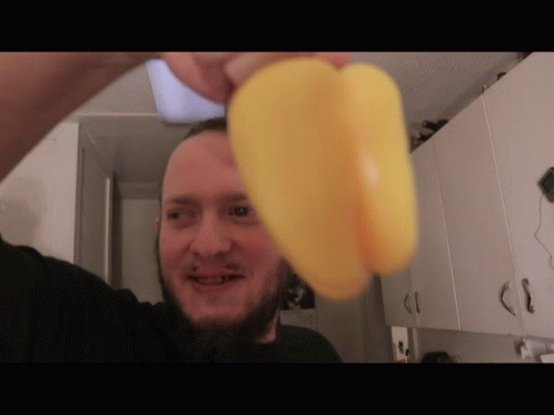 Bearded Man Holding Yellow Pepper GIF