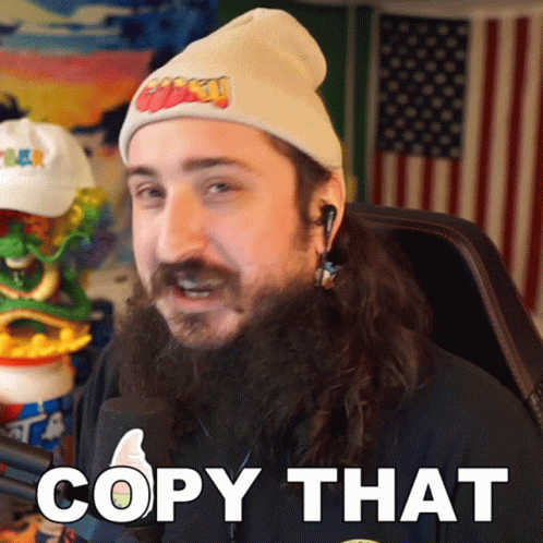 Bearded Man in Beanie and Earbuds Saying Copy That