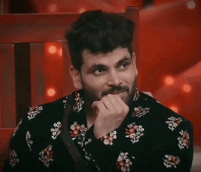 Bearded Man in Black Floral Shirt Hand on Chin