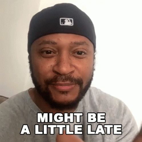 Bearded Man in Black Hat and Gray Shirt Saying Might Be a Little Late