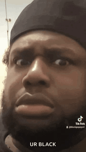 Bearded Man in Black Hat Making Face