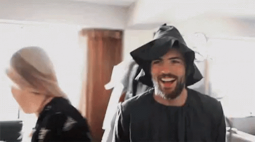 Bearded Man in Black Hat Smiling Near Woman