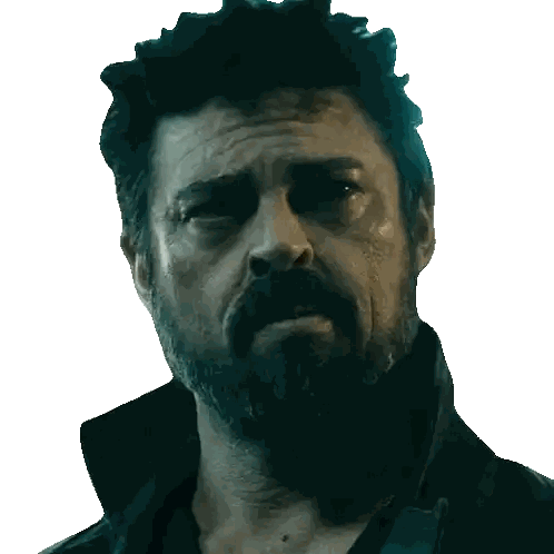 Bearded Man in Black Jacket Looks at Camera