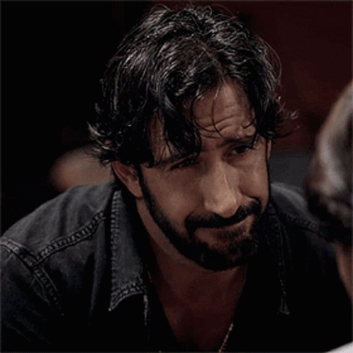 Bearded Man in Black Shirt and Necklace