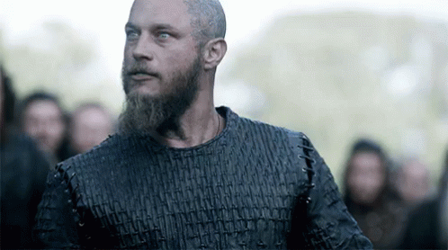 Bearded Man In Black Shirt Facing Crowd GIF