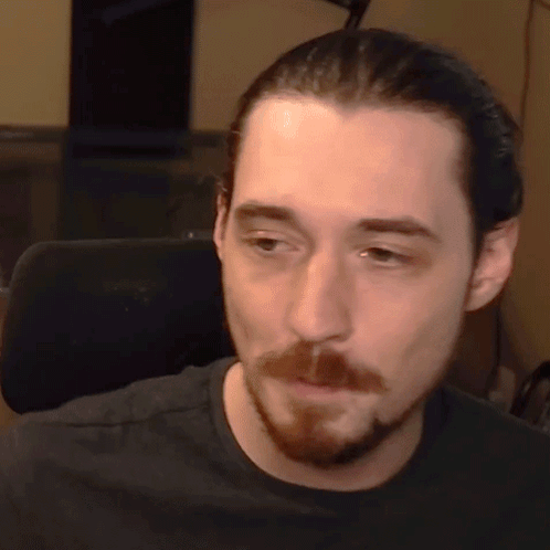 Bearded Man in Black Shirt Looking at Camera