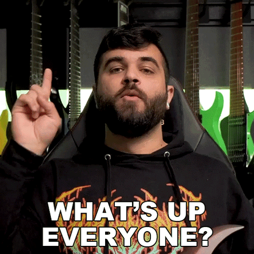 Bearded Man in Black Shirt Saying What's Up Everyone