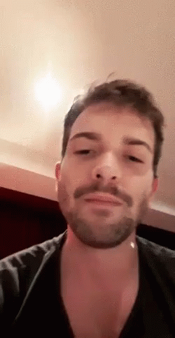 Bearded Man In Black Shirt With Mustache Looking GIF