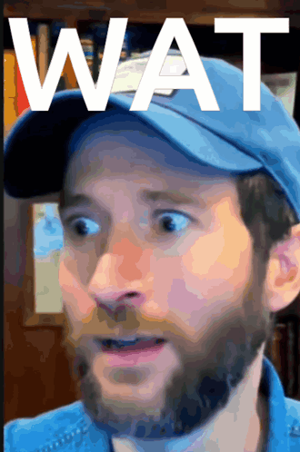 Bearded Man in Blue Hat Saying Wat