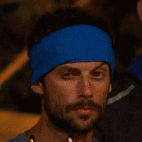 Bearded Man in Blue Headband Looks at Camera