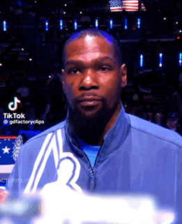 Bearded Man in Blue Jacket Before American Flag