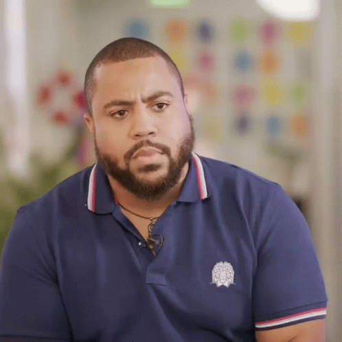 Bearded Man In Blue Polo Shirt With White Emblem GIF