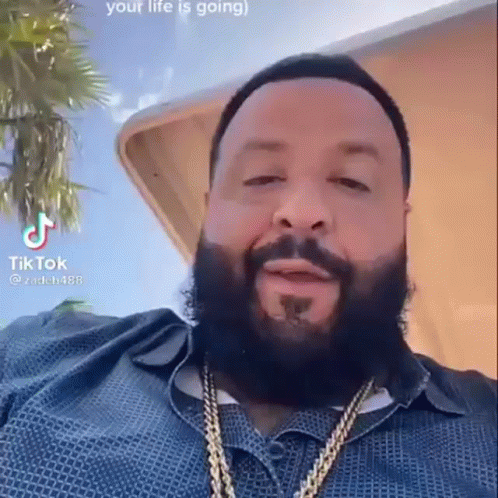 Bearded Man in Blue Shirt and Gold Chains