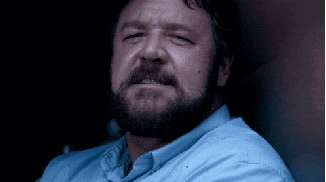 Bearded Man In Blue Shirt Looking At Camera GIF