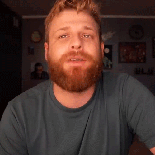 Bearded Man In Blue Shirt Looking At Camera GIF