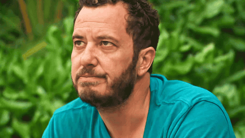 Bearded Man in Blue Shirt Looking to Side
