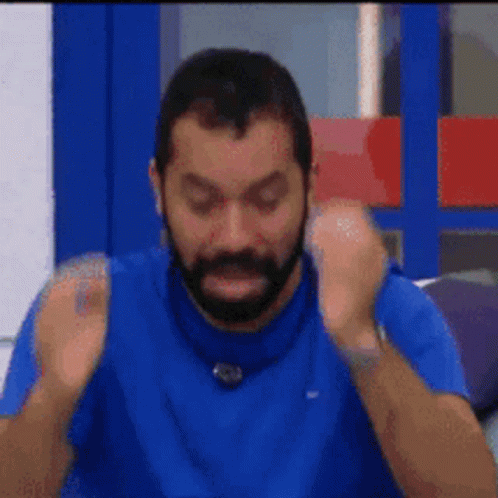 Bearded Man in Blue Shirt Making Funny Face