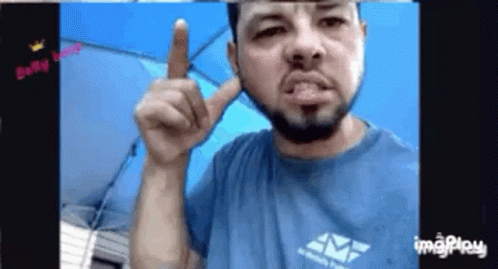 Bearded Man in Blue Shirt Pointing