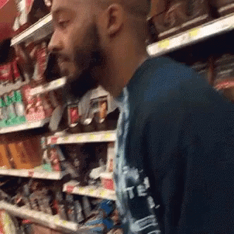 Bearded Man in Blue Shirt Saying T.E.I