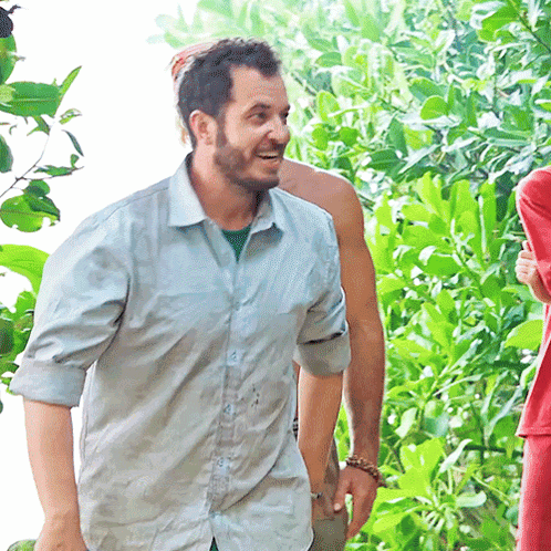 Bearded Man in Blue Shirt Smiling in Woods