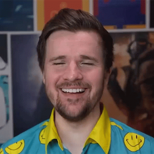 Bearded Man in Blue Shirt With Yellow Smiley Faces