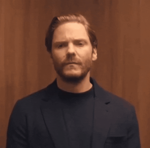 Bearded Man in Blue Suit and Black Sweater