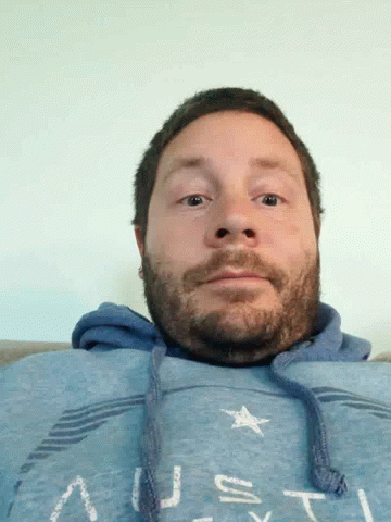 Bearded Man In Blue Sweatshirt Saying Us GIF