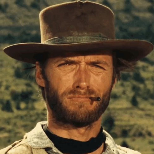 Bearded Man in Cowboy Hat With Cigar