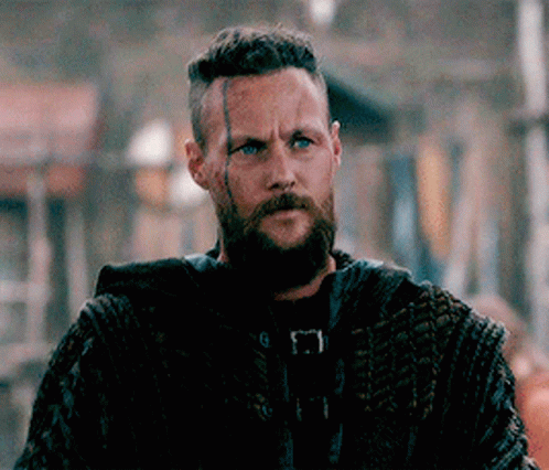 Bearded Man In Crowd Looking At Camera GIF