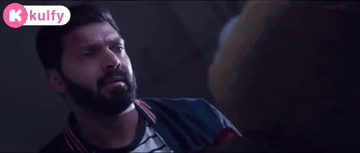 Bearded Man in Dark Room With Kolfy Logo