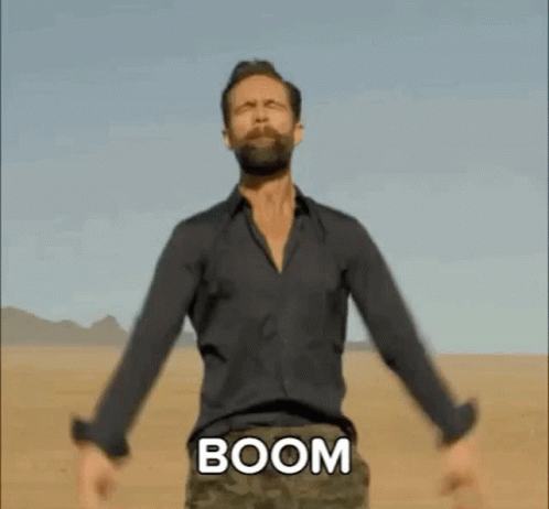 Bearded Man In Desert Arms Outstretched Chest Says Boom GIF