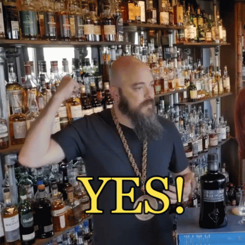 Bearded Man In Front Of Alcohol Shelf Saying Yes GIF