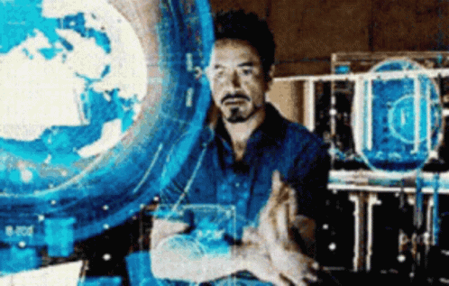 Bearded Man In Front Of Blue Globe GIF
