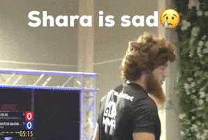 Bearded Man in Front of Shara is Sad Sign