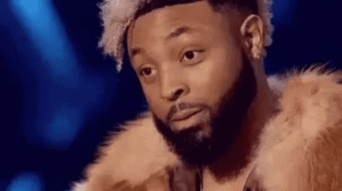 Bearded Man in Fur Coat on Stage