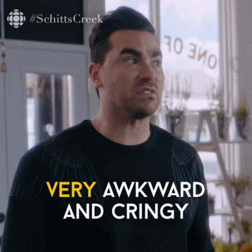 Bearded Man In Glasses And Suit Sitting On Couch GIF