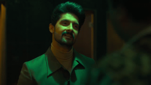 Bearded Man In Green Jacket And Turtleneck Smiling GIF