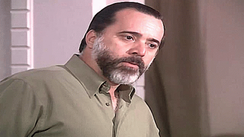 Bearded Man in Green Shirt Looking at Camera